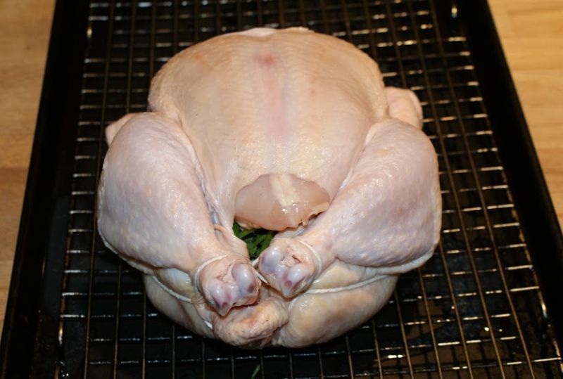 The whole chicken is rubbed with vermouth and allowed to stand for several hours.