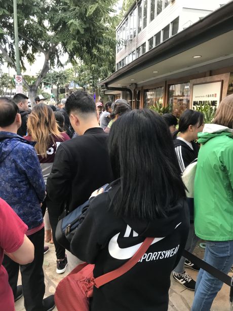 A line of customers waits to get inside Marukame Udon restaurant in Waikiki.