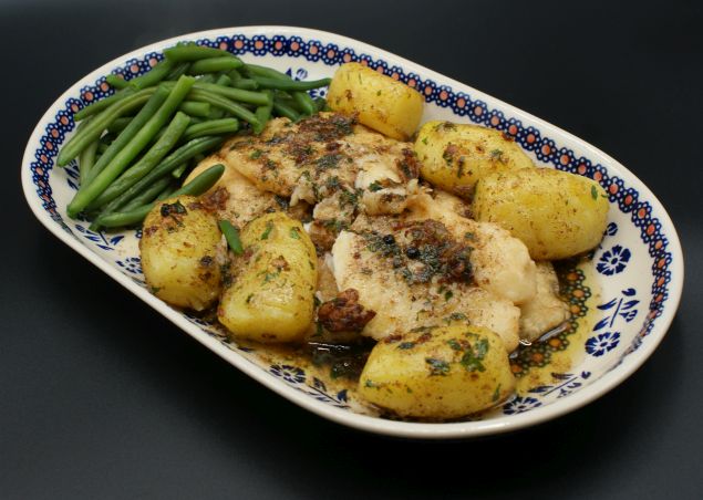 Orange roughy fillets with a brown butter sauce, boiled potatoes and green beans