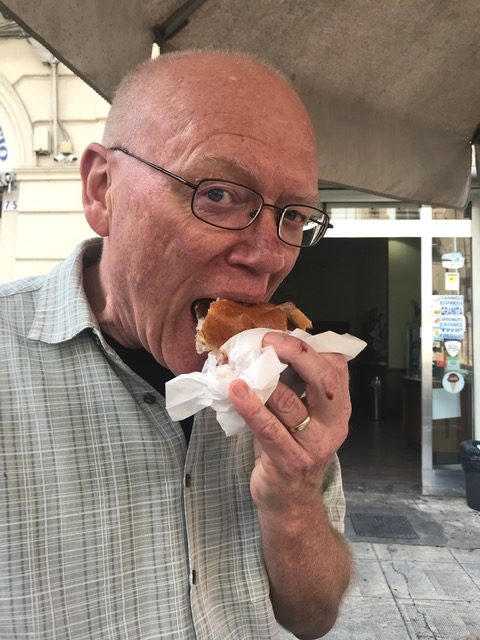 Enjoying a gelato en brioche at Gelateria Ciccio Adelfio in Palermo, Sicily.