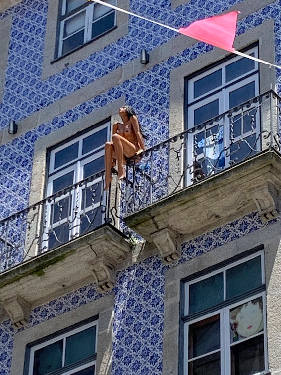 A nude mannekin on a balcony in Porto.