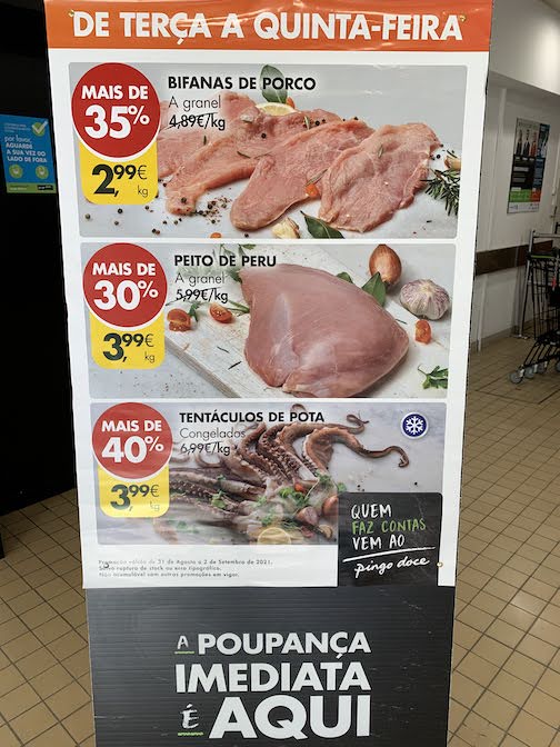 A placard illustrating specials at the local grocery store in Porto