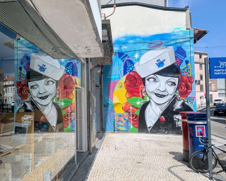 Street art of a girl in a sailor's hat in Porto.