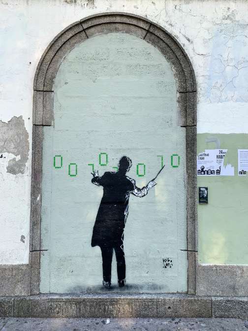 Street art of a conductor by STRA in Porto, Portugal.