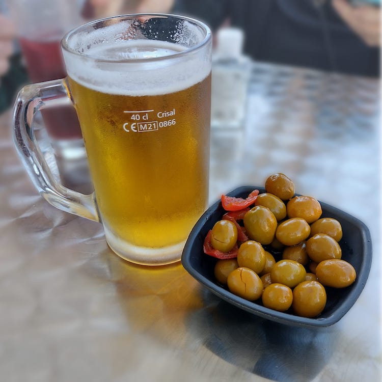 Cold beer and spicy olives at 100 Montaditos in Cascais, Portugal