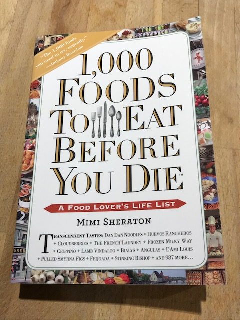 A photo of "1,000 Foods to Eat Before You Die" by Mimi Sheraton.