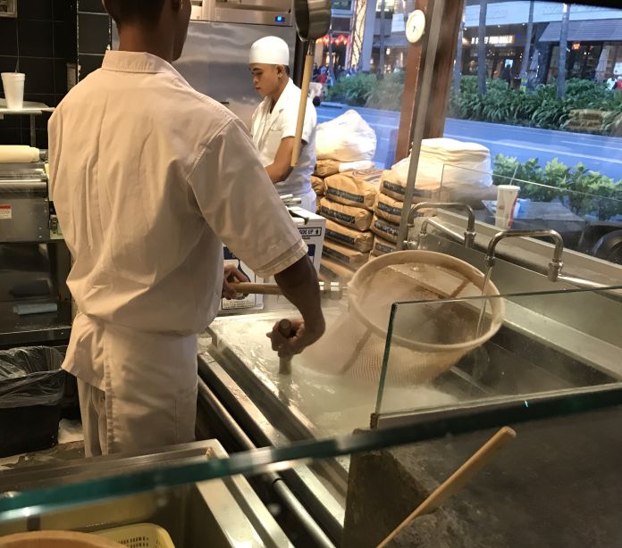 A line cook prepares fresh udon noodles at the Marukame Udon restaurant on Waikiki.