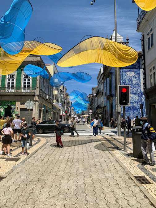 Wispy cloth sculptures suspended over the Rua Santa Catarina in Porto.