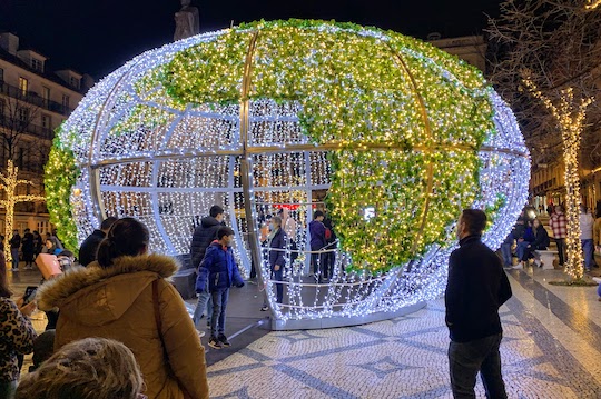 A lighted structure in the shape of a globe - Chiado neighborhood, Lisbon.