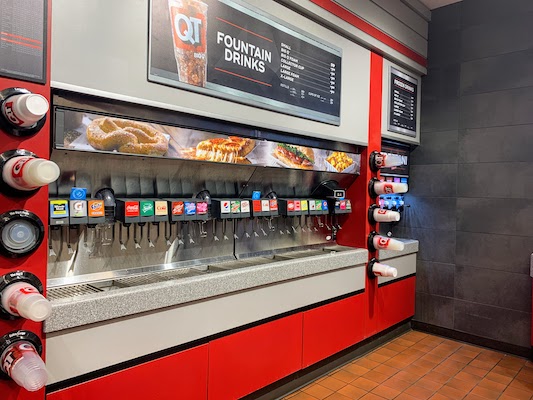 A large drink station in a convenience store with 24 kinds of soft drinks