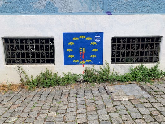 A mural by Filho Bastardo in Porto - the EU flag bleeding