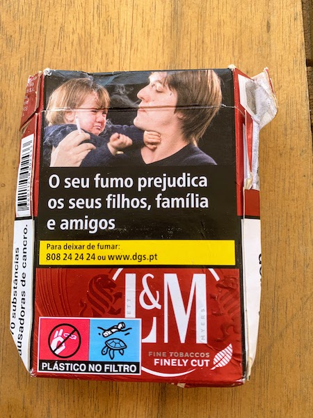 A Portuguese cigarette pack with the warning "Your smoking harms your children, family and friends"