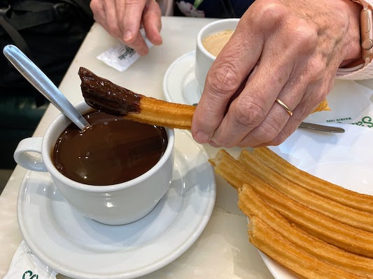 Dipping churros in chocolate