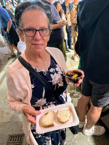 Mary with a cheese tapa and a glass of vermut