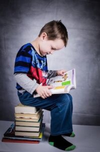 A small boy reading a book.