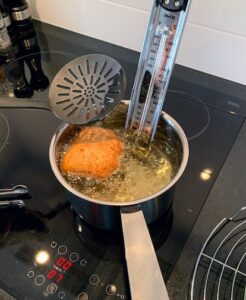 A malasada being fried.