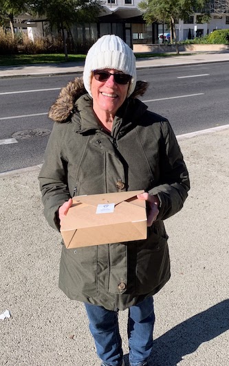 Mary holding the box with our first order from Too Good To Go