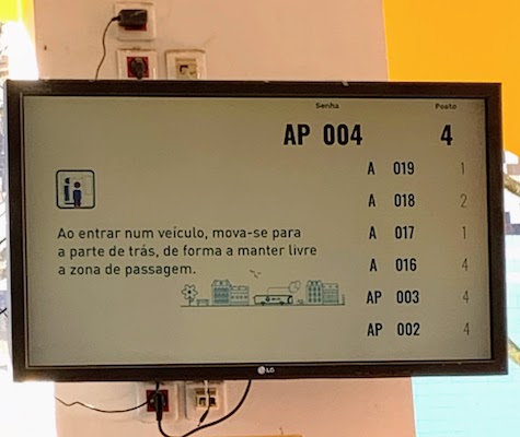 A monitor in the bus company office showing which ticket numbers are being served.