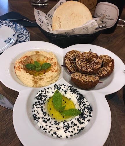 Our appetizer at Tayybeh - hummus (top left), falafel (top right), yogurt and olive oil (bottom).