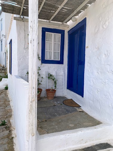 9863 - White and blue house A whitewashed house with a blue door and window frame on Hydra.