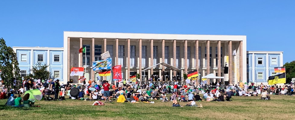 A group of attendees to World Youth Day gathered on the campus of the University of Lisbon.