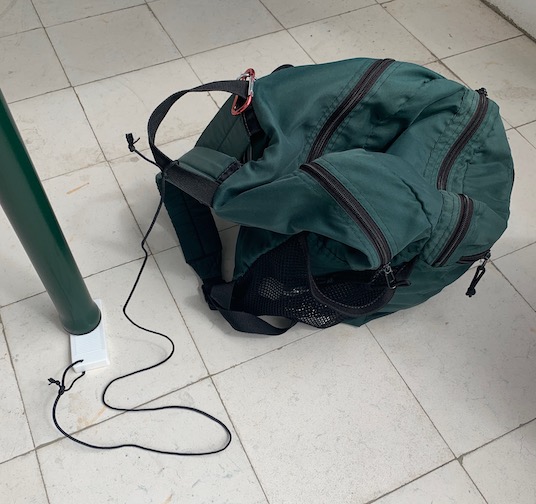 Our doorstop "table stabilizer" attached to Mike's day pack with a short cord.