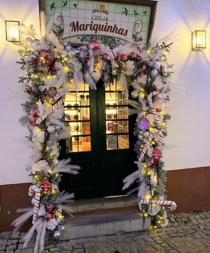 A shop door decorated for Christmas in Obidos, December, 2023.