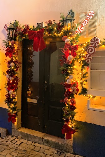 A shop door decorated for Christmas in Obidos, December, 2023.