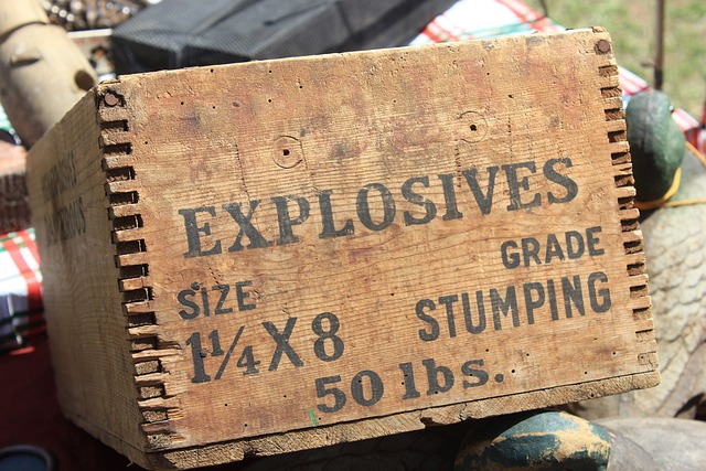 An old wooden box used for packaging dynamite, with the word "EXPLOSIVES" printed on the side.