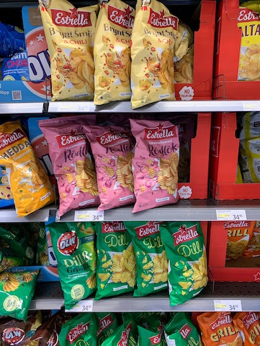 Bags of potato chips in a grocery store on Vaxholm. Each priced at SEK 34.95.