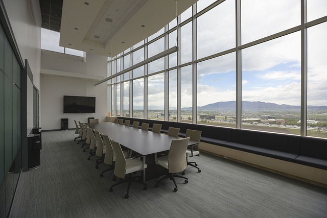 A large conference room with a wall of windows looking out towards mountains. The kind of office we could never afford!