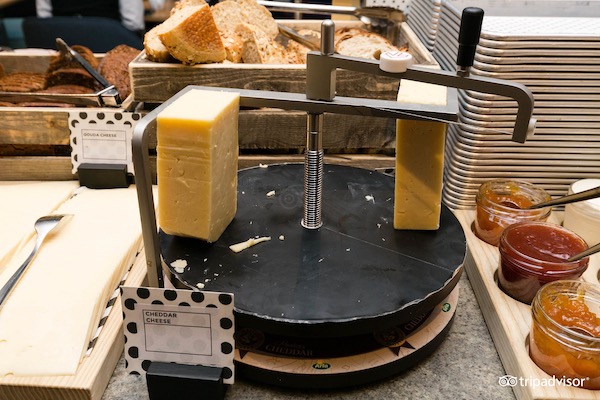 A breakfast buffet selection of cheeses, breads, and jam at a Swedish hotel.