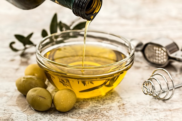 Olive oil being poured into a small bowl.