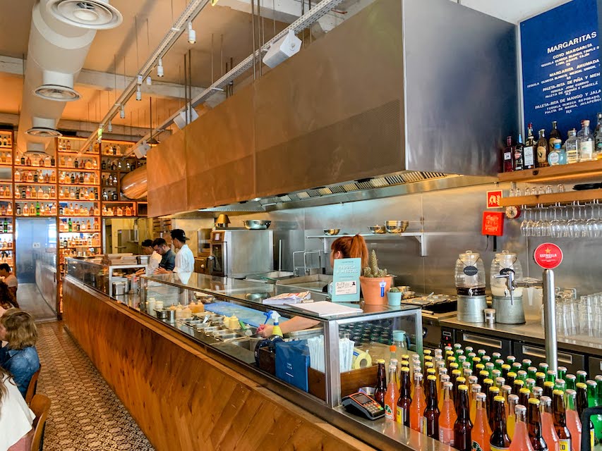 The interior of Coyo Taco in Principe Real, Lisbon, showing the kitchen and prep area.