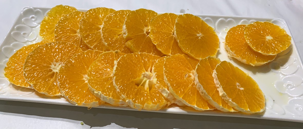 A simple dessert of sliced oranges.