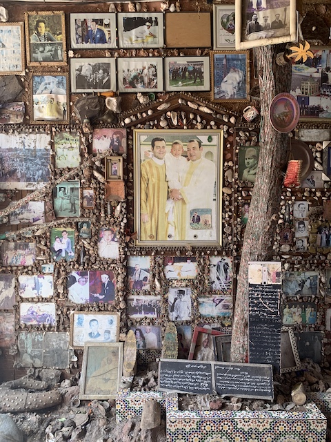 A wall in the Marrakech medina with photographs and other commemorative items related to the King and royal family.