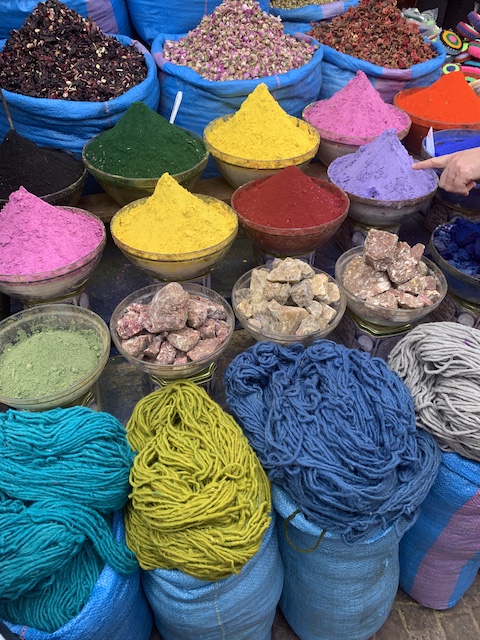 Bowls of brightly colored dye and dyed yarn in the medina in Marrakech.