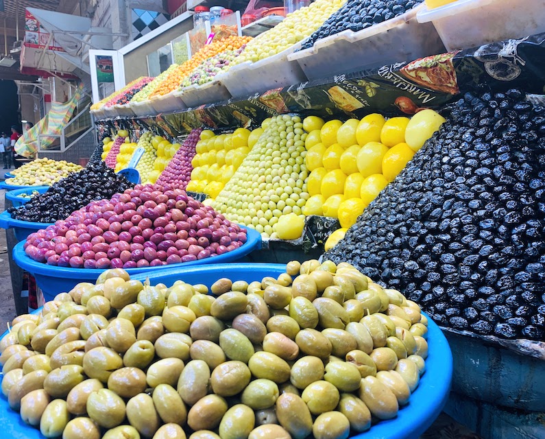 Fresh olives and fruit displayed for sale in the medina in Meknes