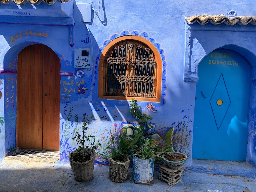 The exterior of a home and shop in Chefchaouen, with the traditional blue paint.