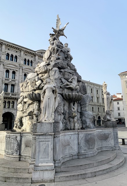 The Fountain of the Four Continents in the Piazza Unità in Trieste. A statue of King Charles VI is in the background, right.