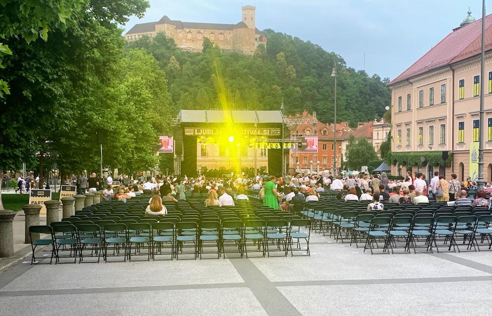 The plaza at Park Zvezda in Ljubljana, with a stage and chairs for the first concert of the Ljubljana festival.