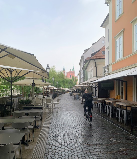 An early morning view of a nearly deserted street along the Ljubljanica River.