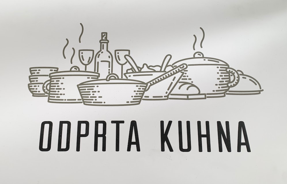 A sign for Odprta Kuhna - the Open Kitchen