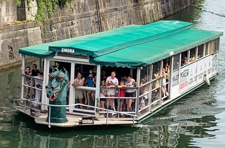 A boat named "Emona" on the Ljubljanica River.