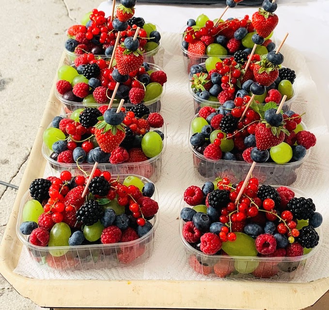 Fresh fruit - blackberries, raspberries, blueberries, grapes, and currants - for sale at the market in Ljubljana.