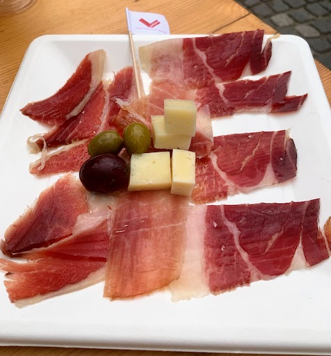 A starter with three varieties of prosciutto, cheese, and olives