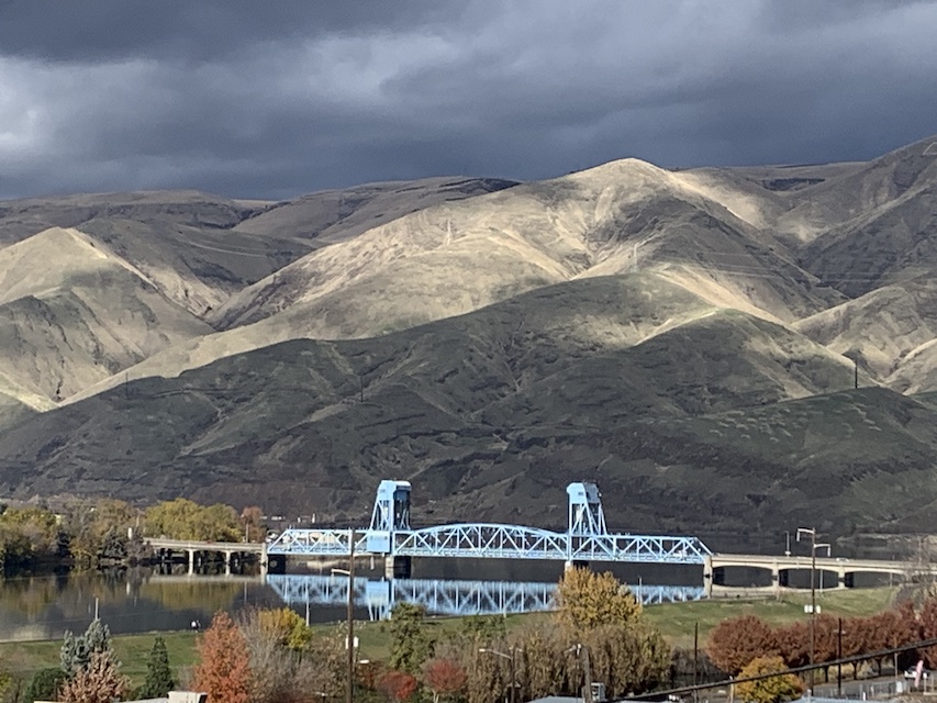 The Palouse on a day when storms were threatening. It appears to be grey and tan. In the foreground is one of the bridges that connect Idaho to Washington.