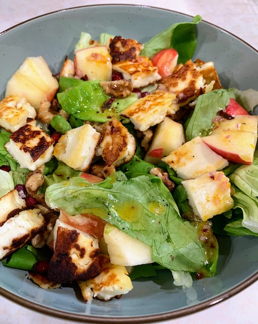 A close up photo of the salad made with apples, halloumi cheese, and walnuts.