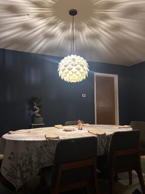 The new light installed and creating interesting shadow effects on the walls and ceiling of our dining room.