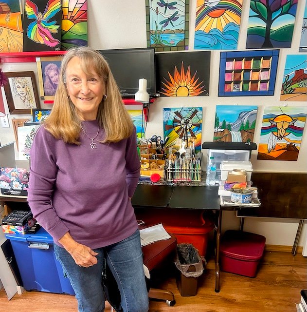 Polly Walker in her studio, surrounded by her artwork.